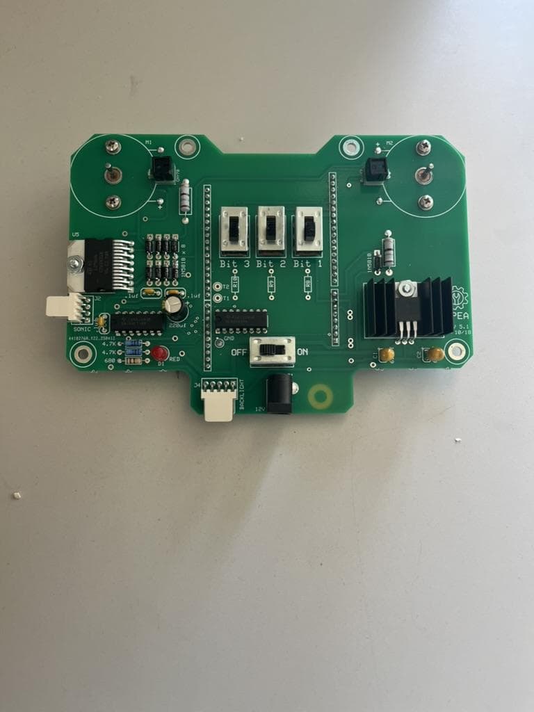 Fully populated green controller board with headers, chips and connectors.