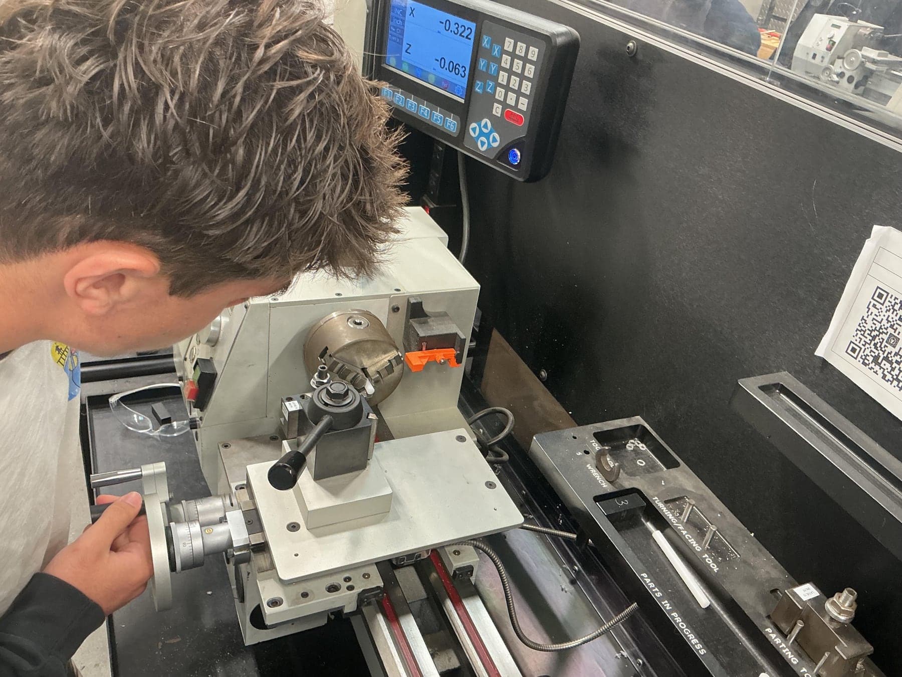 Machining the knob on a manual lathe, the digital readout visible behind.