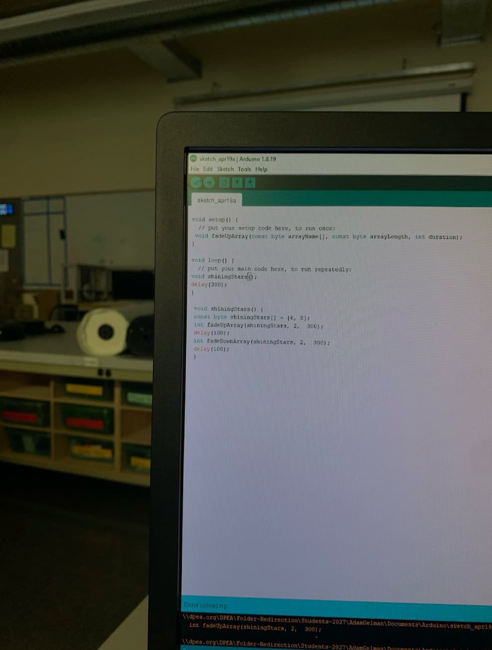 Monitor showing an Arduino sketch with fade-up and fade-down functions for LEDs.
