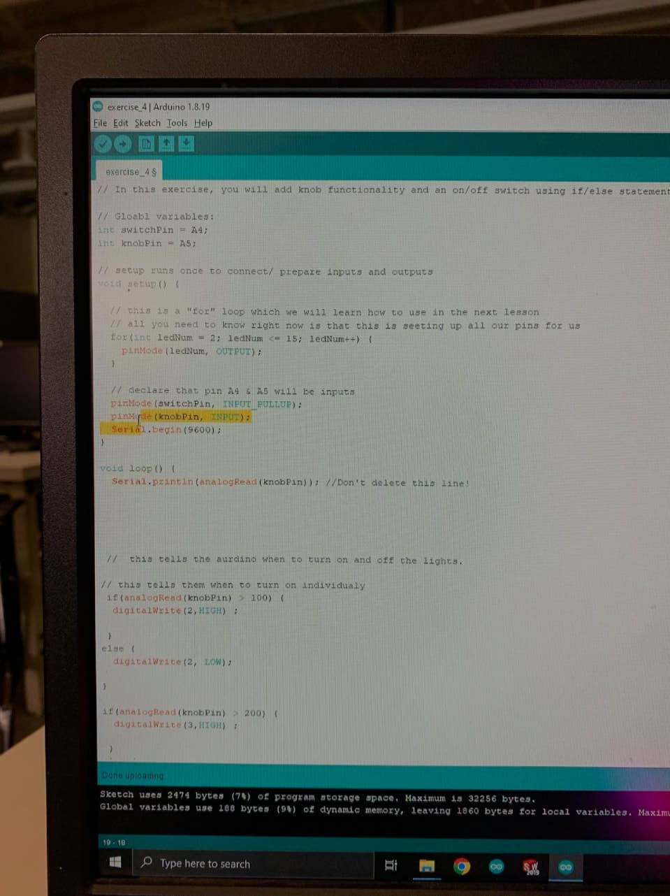 Monitor showing an Arduino sketch that reads a knob and a switch and lights LEDs with if/else statements.