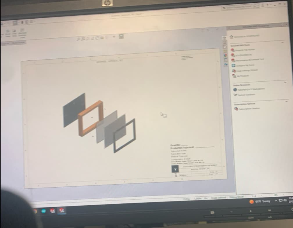 Monitor showing the SolidWorks exploded assembly of the shadow box layers and frame.